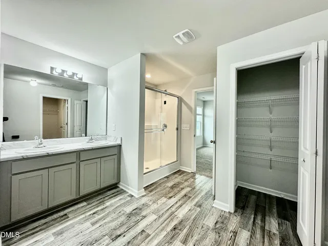 a bathroom with a double vanity sink and a mirror