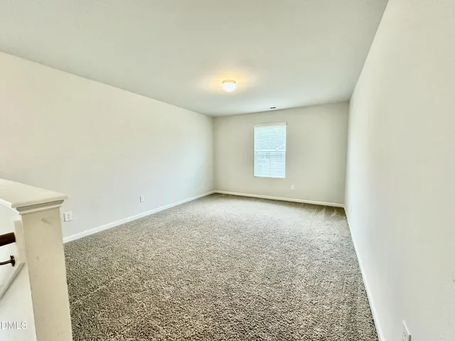 an empty room with a empty space and window