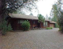 12293 Mac's Road Redding, CA 96003 - Photo 1 of 1 a view of a house with a yard and garage