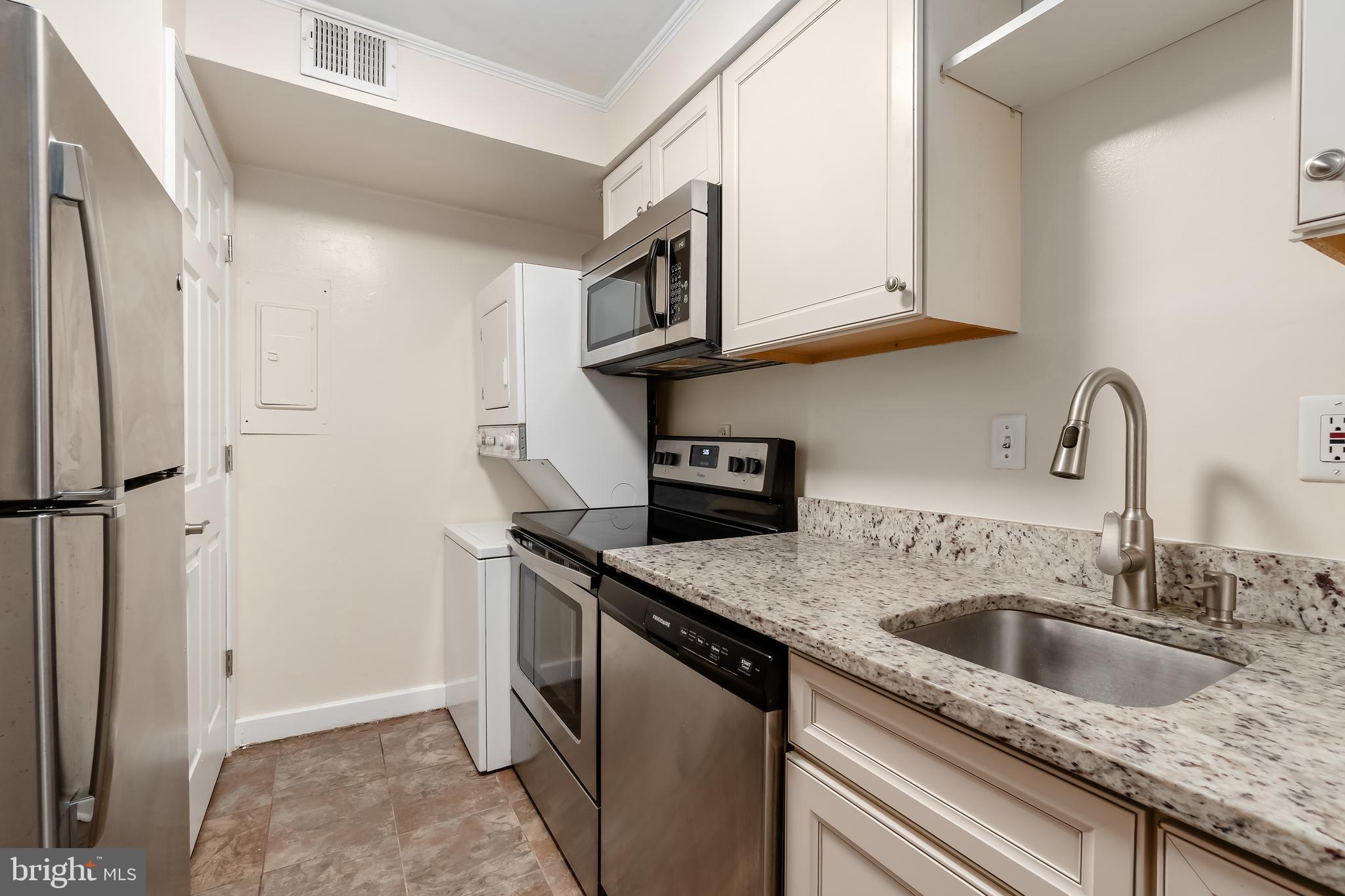 2123 Suitland Terrace Southeast, Unit B Washington, DC 20020 - Photo 11 of 25 a kitchen with stainless steel appliances granite countertop a sink stove and refrigerator