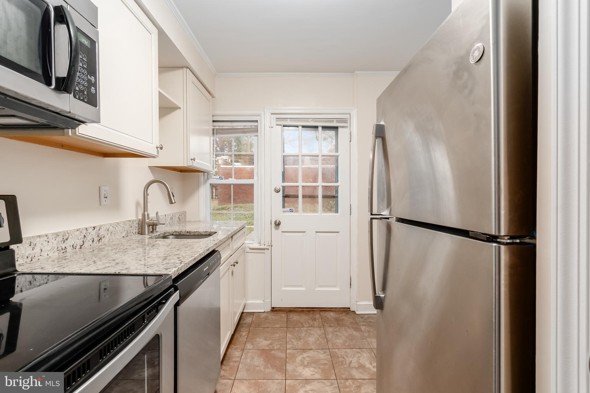 2123 Suitland Terrace Southeast, Unit B Washington, DC 20020 - Photo 12 of 25 a kitchen with a refrigerator and a sink