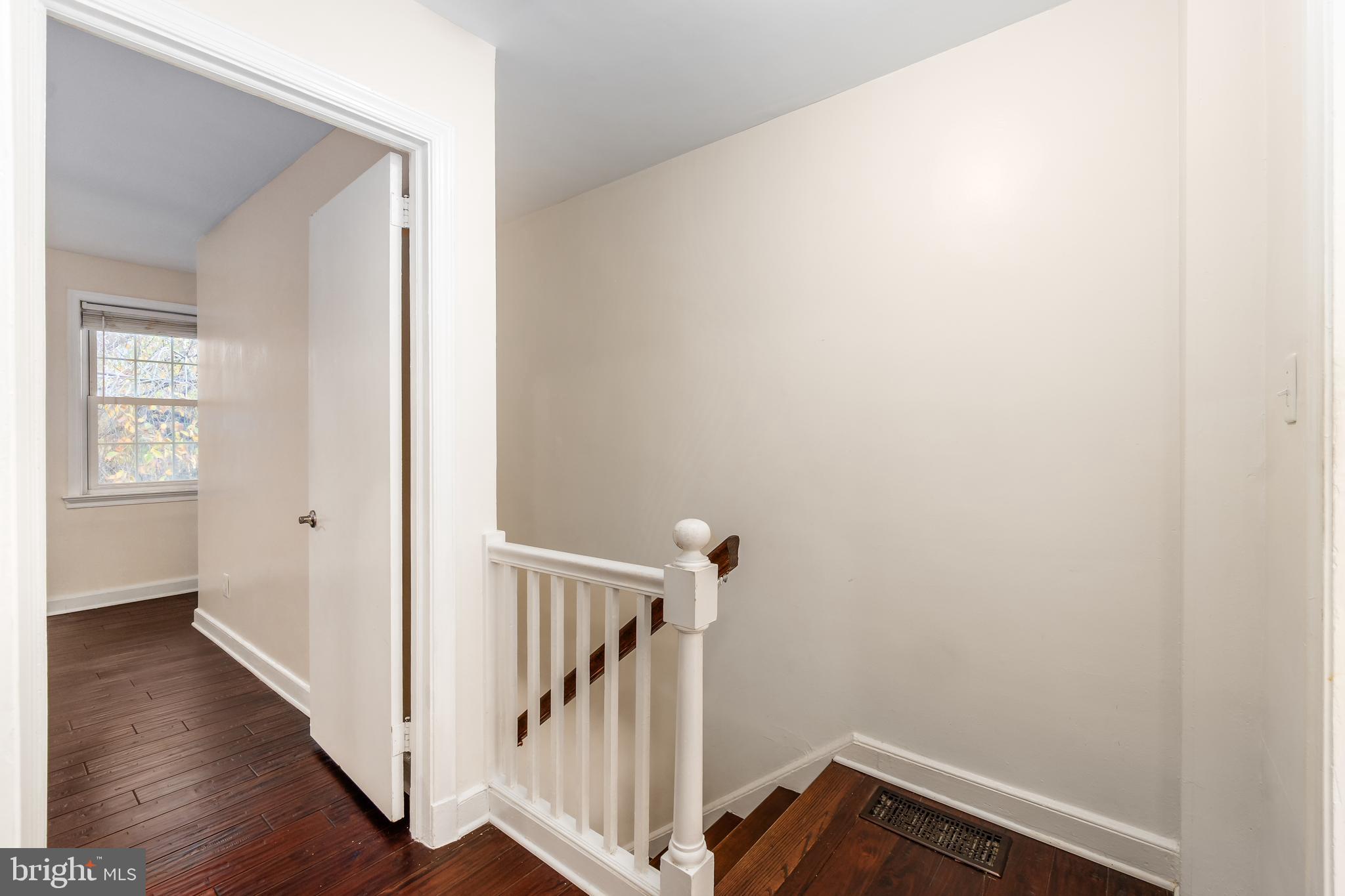 2123 Suitland Terrace Southeast, Unit B Washington, DC 20020 - Photo 13 of 25 a view of a hallway with wooden floor and staircase