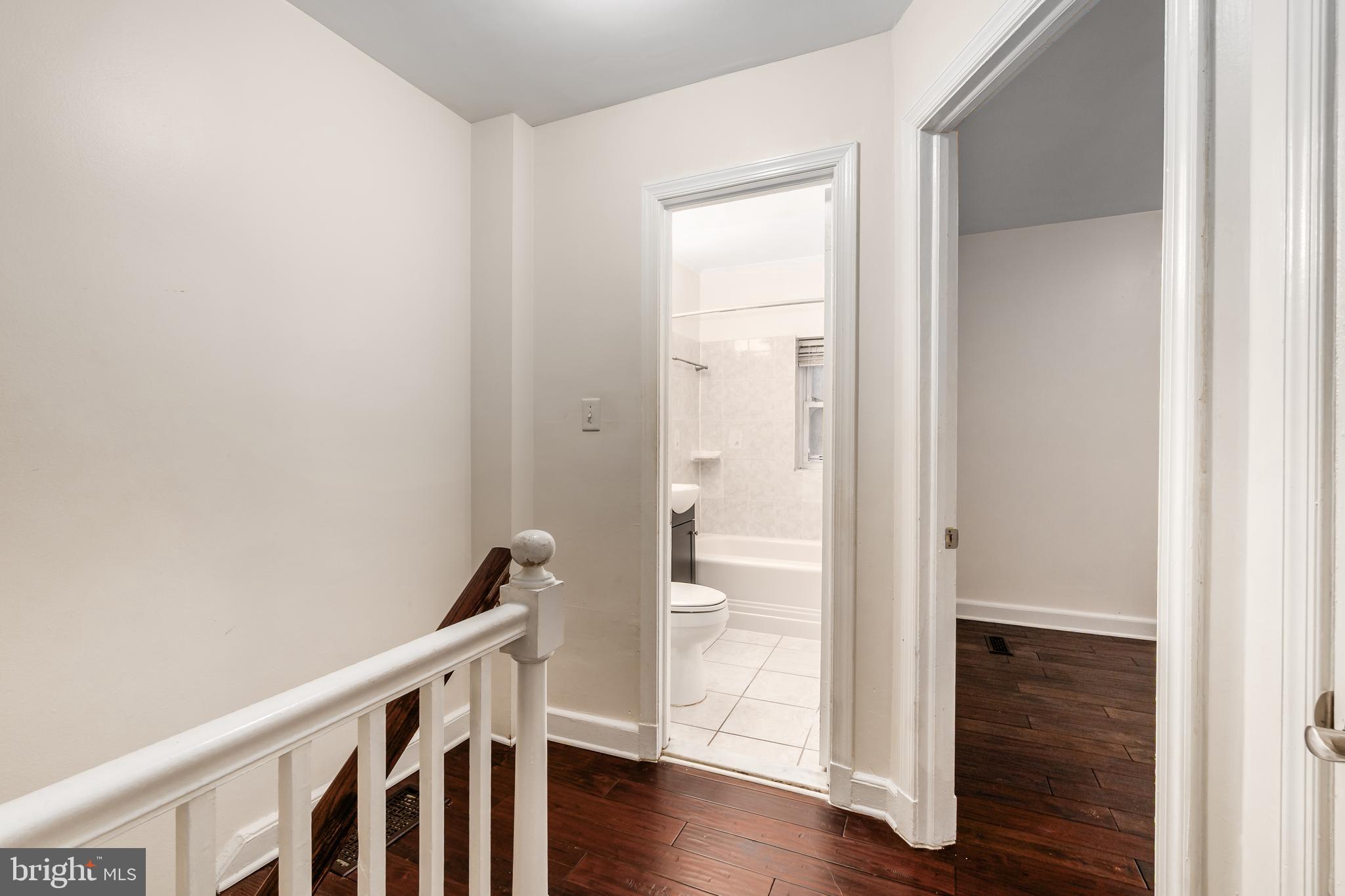 2123 Suitland Terrace Southeast, Unit B Washington, DC 20020 - Photo 14 of 25 a view of a hallway with wooden floor and staircase