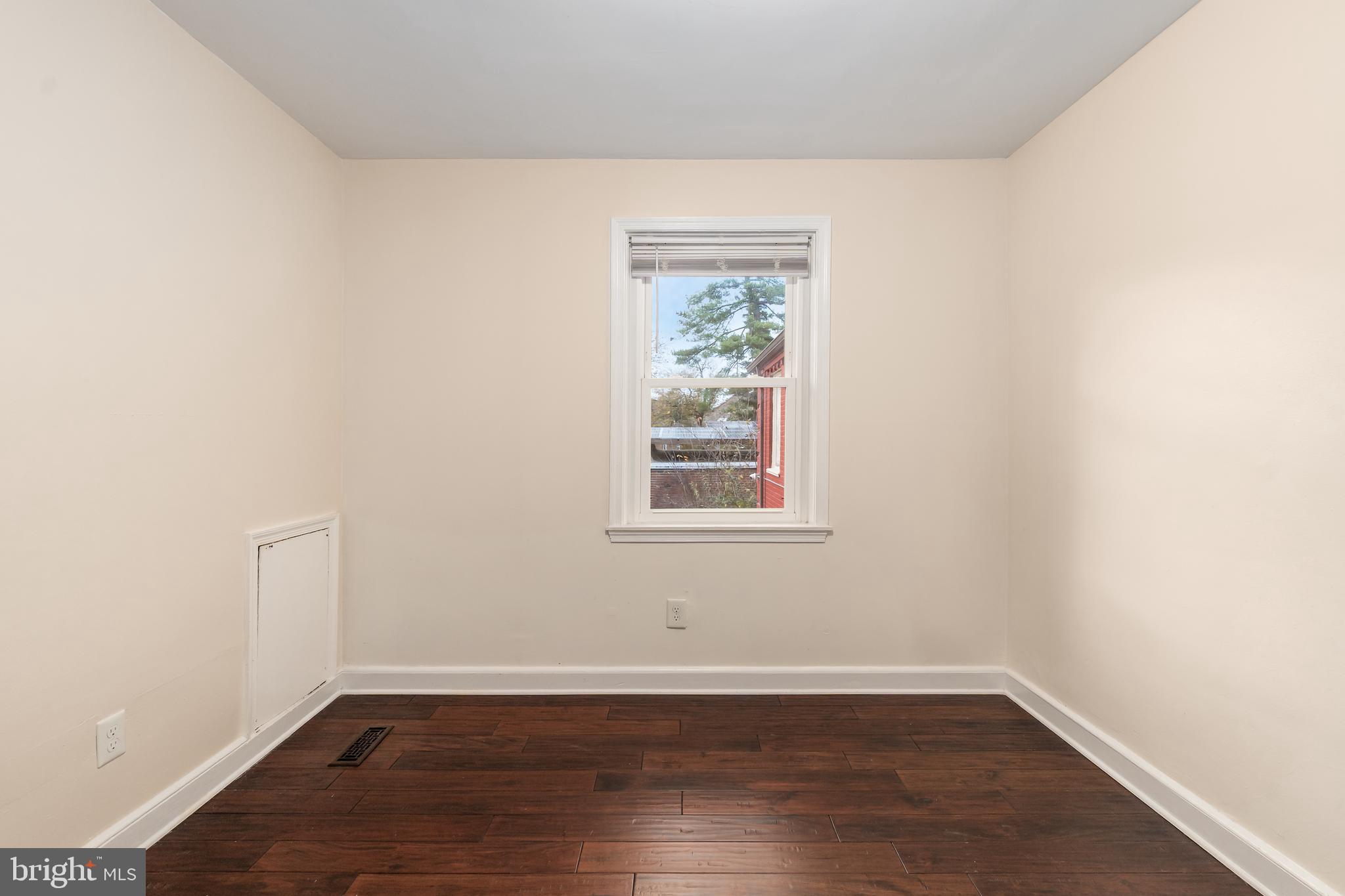 2123 Suitland Terrace Southeast, Unit B Washington, DC 20020 - Photo 16 of 25 an empty room with wooden floor and a window