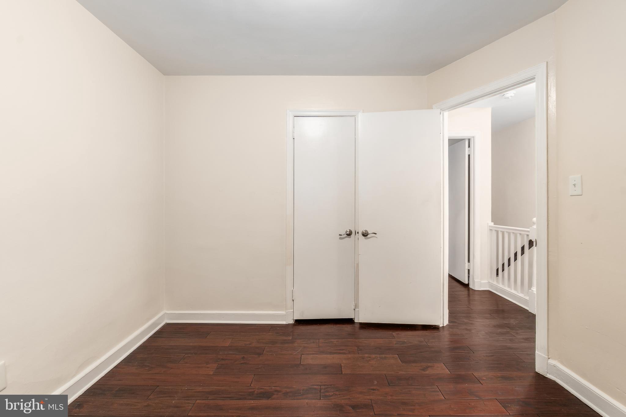 2123 Suitland Terrace Southeast, Unit B Washington, DC 20020 - Photo 17 of 25 a view of an empty room with wooden floor