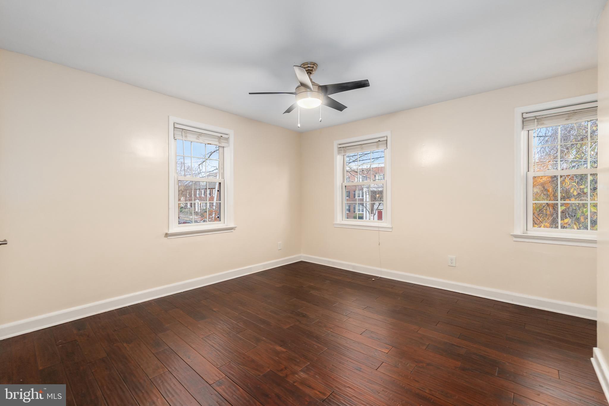 2123 Suitland Terrace Southeast, Unit B Washington, DC 20020 - Photo 18 of 25 a view of an empty room with wooden floor and a window