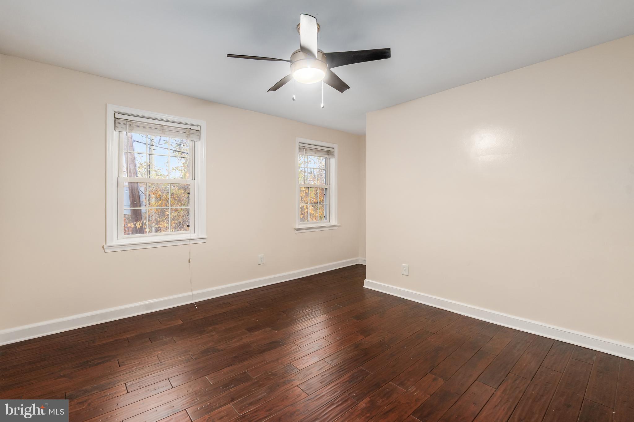 2123 Suitland Terrace Southeast, Unit B Washington, DC 20020 - Photo 19 of 25 a view of an empty room with wooden floor and a window