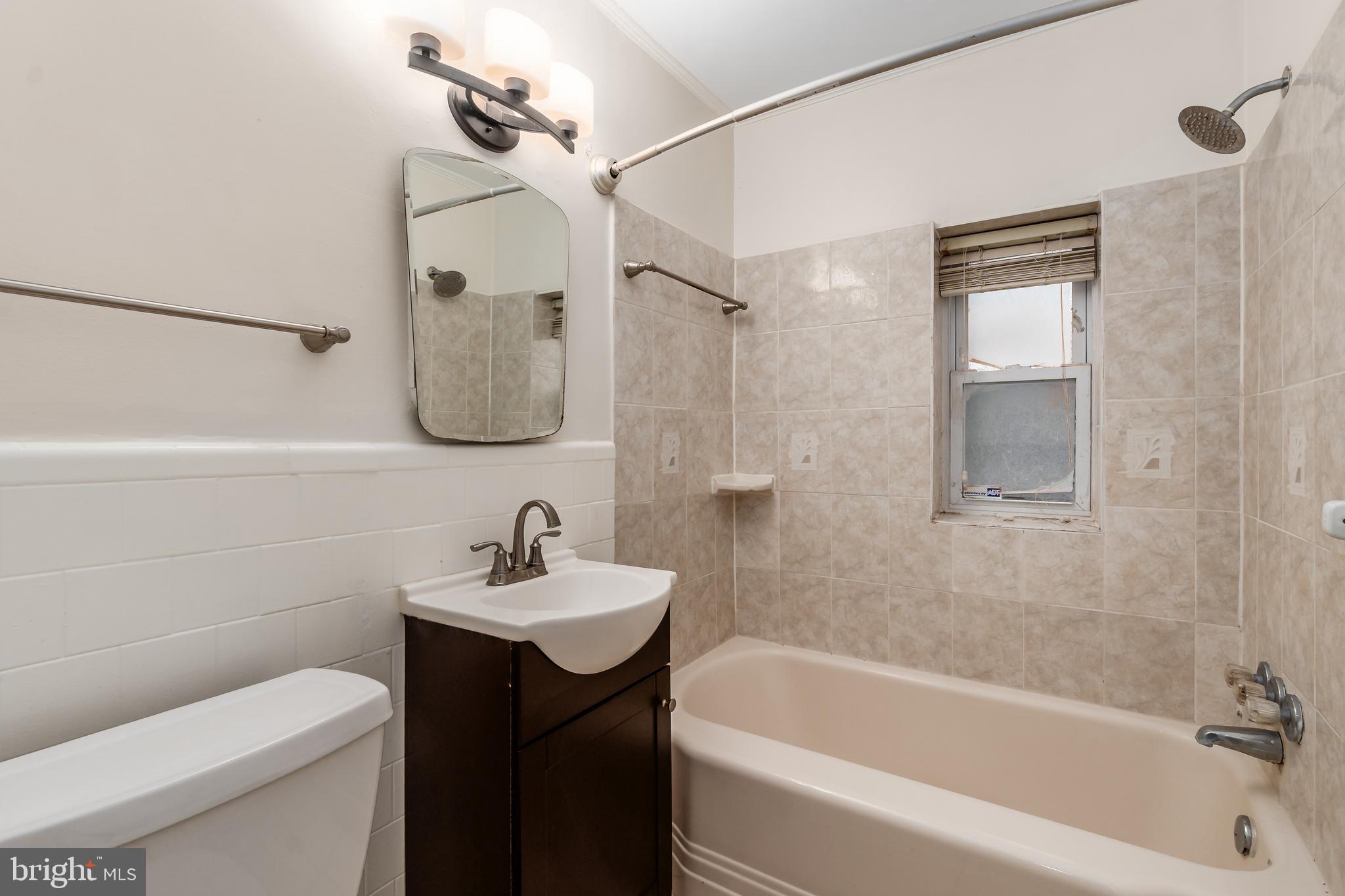 2123 Suitland Terrace Southeast, Unit B Washington, DC 20020 - Photo 22 of 25 a bathroom with a sink toilet and shower