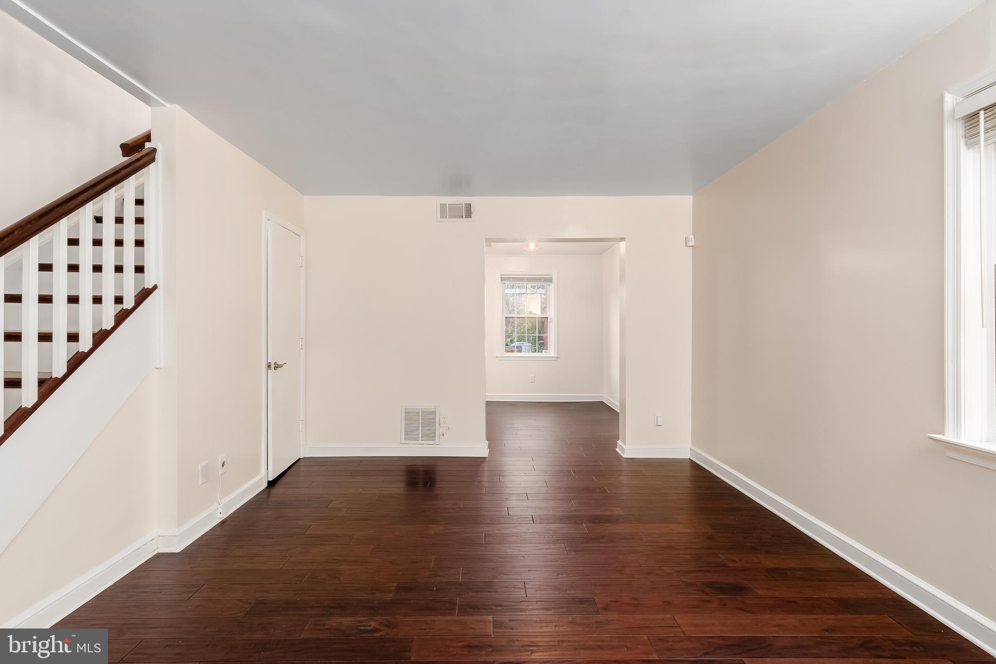 2123 Suitland Terrace Southeast, Unit B Washington, DC 20020 - Photo 4 of 25 a view of an empty room with wooden floor and stairs