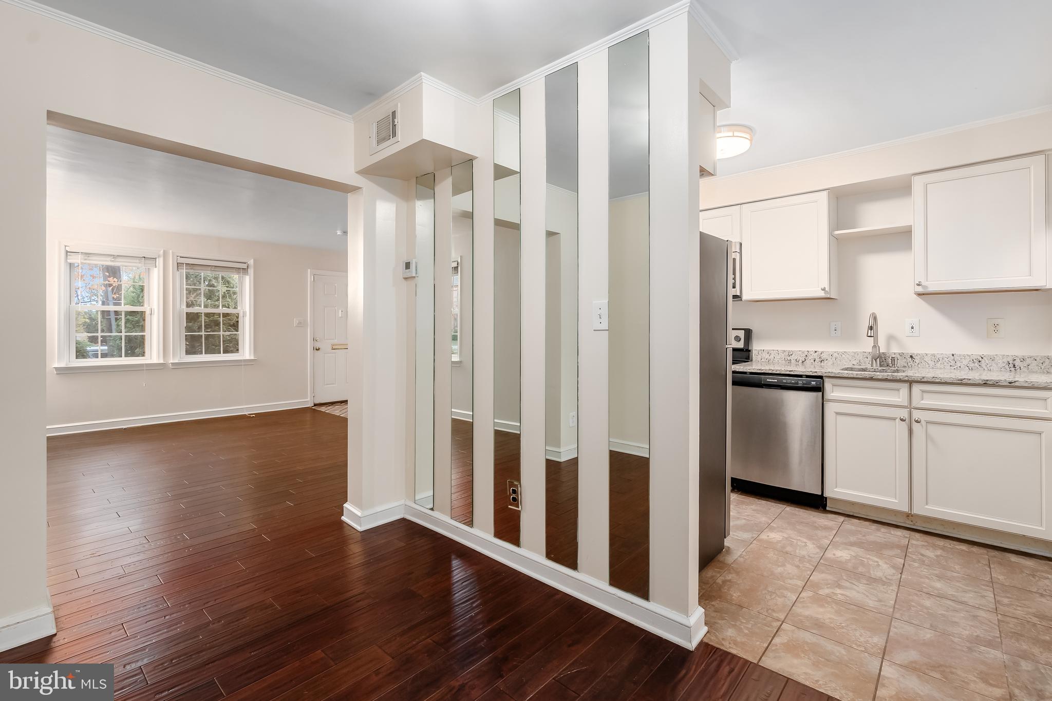 2123 Suitland Terrace Southeast, Unit B Washington, DC 20020 - Photo 10 of 25 a kitchen with granite countertop a refrigerator sink and cabinets