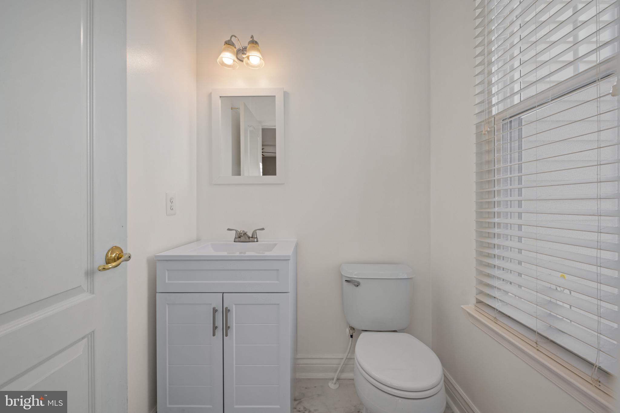 8 Porch Street Clayton, NJ 08312 - Photo 14 of 31 a bathroom with a toilet a sink and mirror