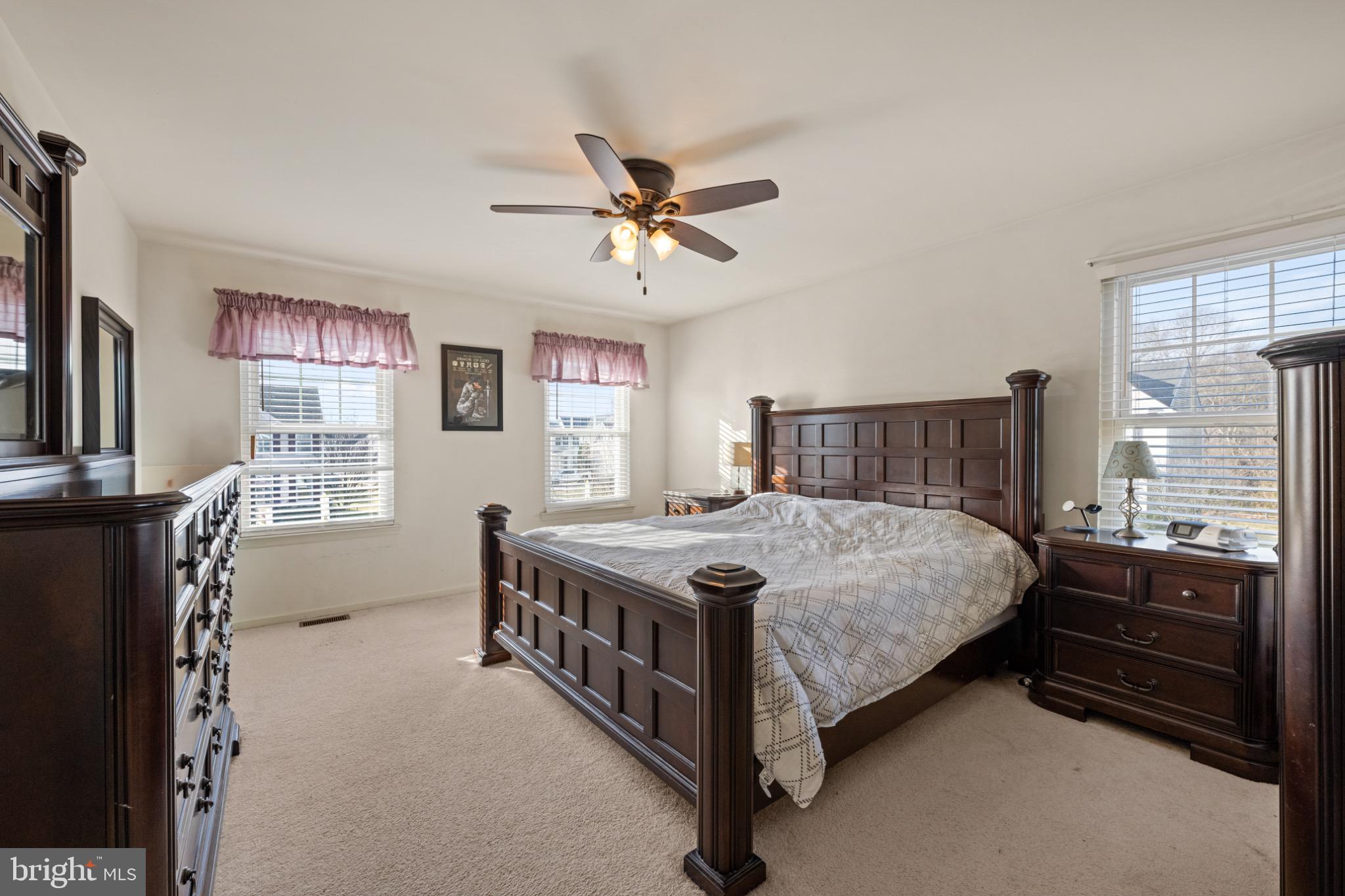 8 Porch Street Clayton, NJ 08312 - Photo 15 of 31 a bedroom with a bed next to a window with a chandelier