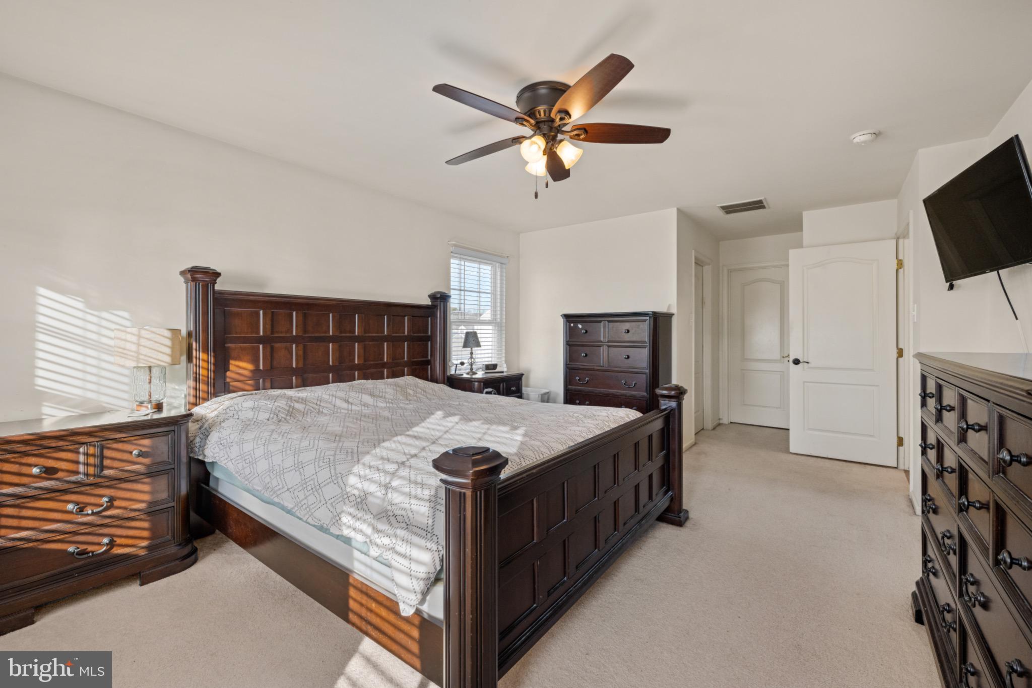 8 Porch Street Clayton, NJ 08312 - Photo 17 of 31 a bedroom with a bed a flat screen tv and a fireplace