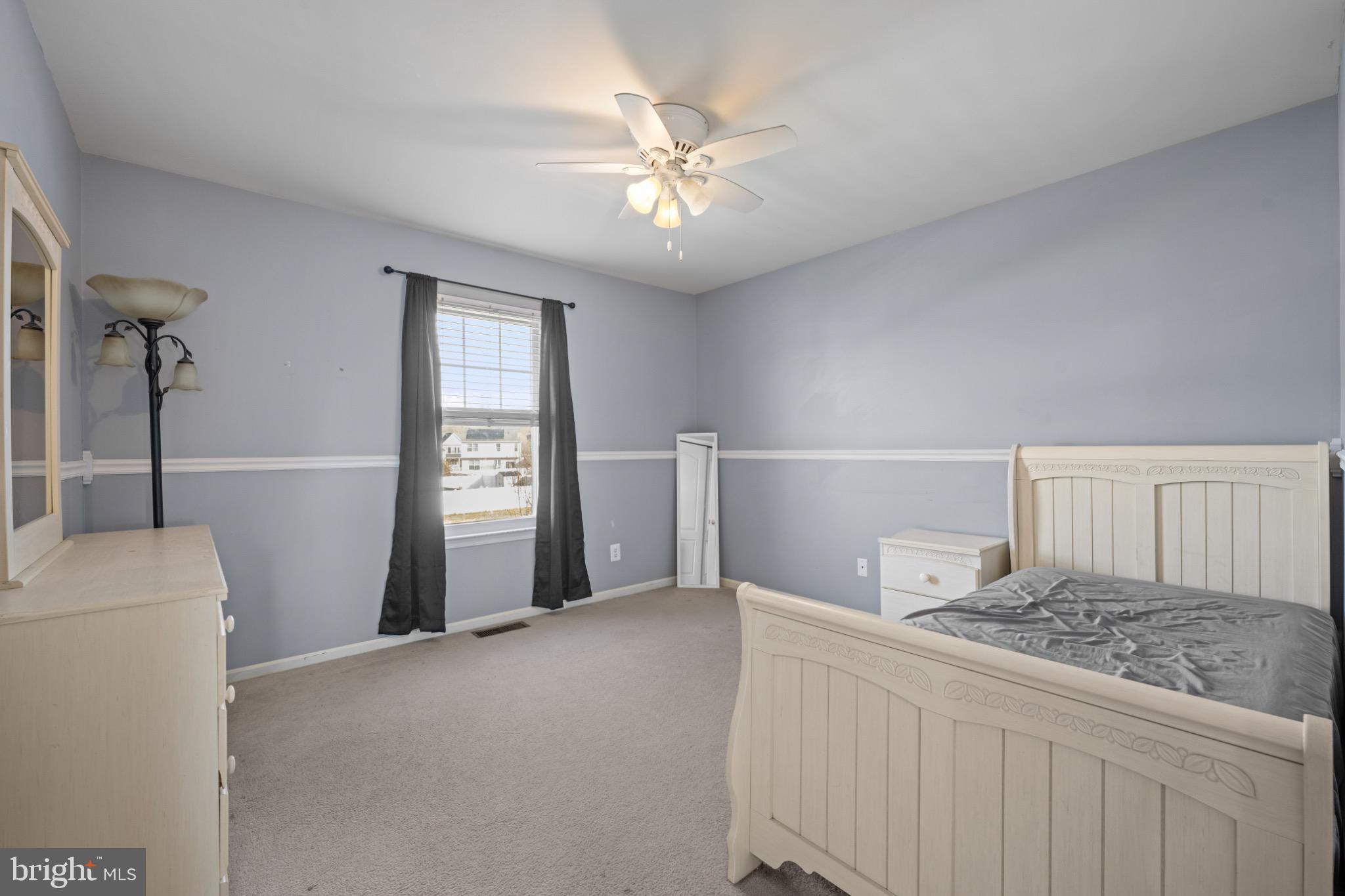 8 Porch Street Clayton, NJ 08312 - Photo 22 of 31 a living room with a bed and a chandelier