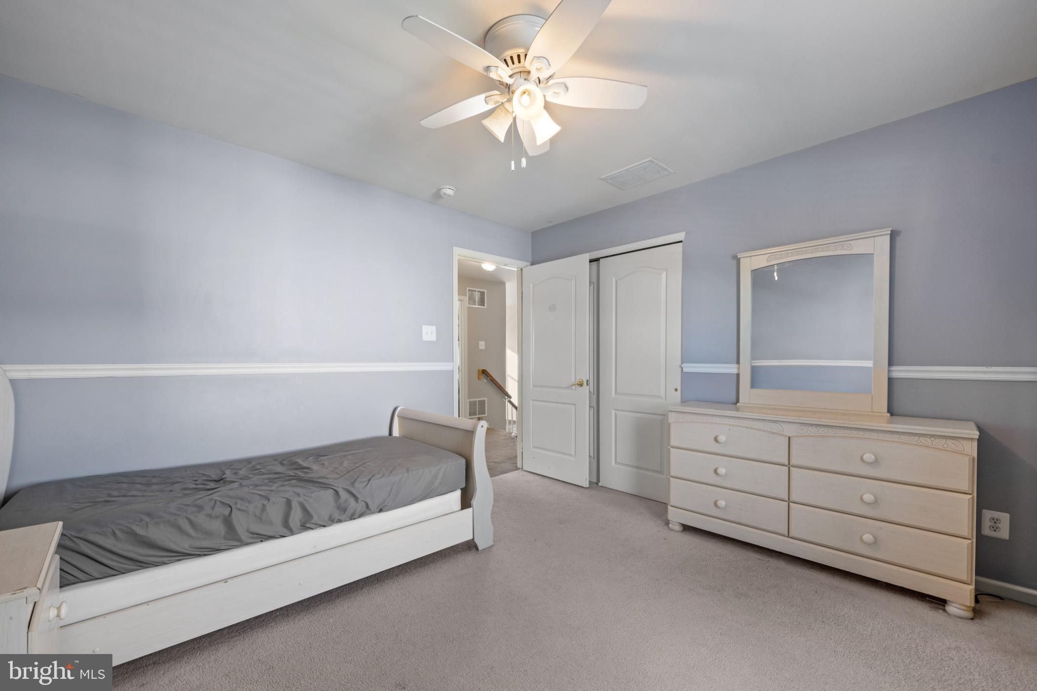 8 Porch Street Clayton, NJ 08312 - Photo 23 of 31 a spacious bedroom with a bed and a chandelier