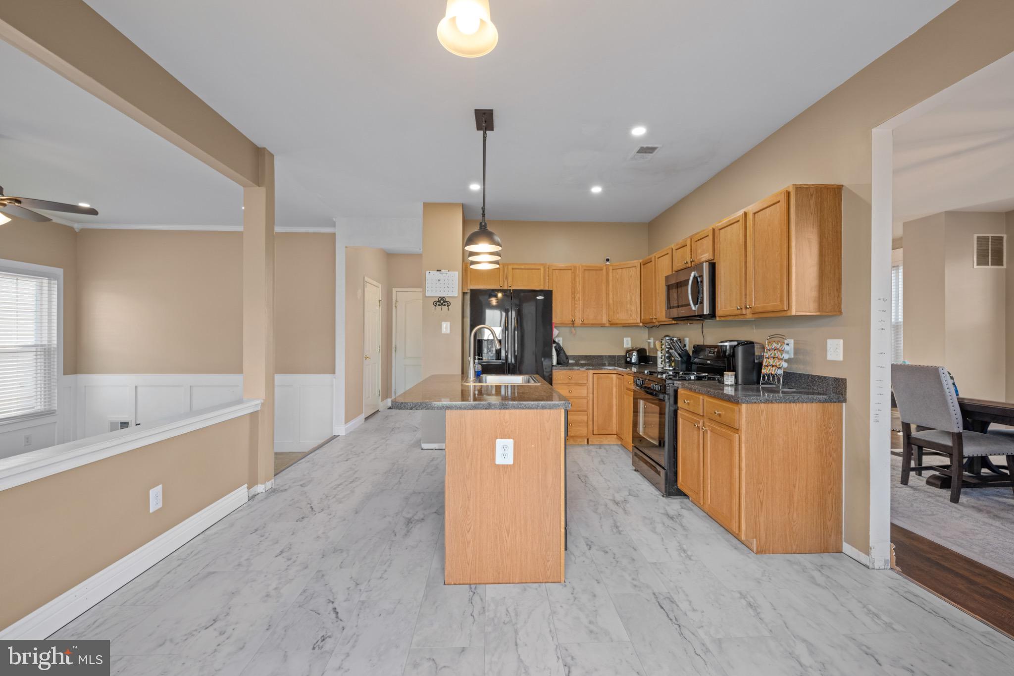 8 Porch Street Clayton, NJ 08312 - Photo 10 of 31 a large kitchen with stainless steel appliances kitchen island granite countertop a large counter top cabinets and a sink