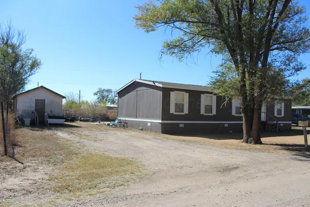 a house that has a tree in front of it