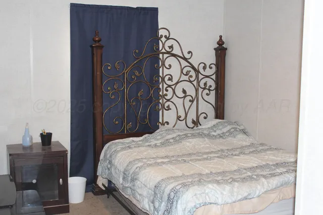 a bedroom with a bed and a table