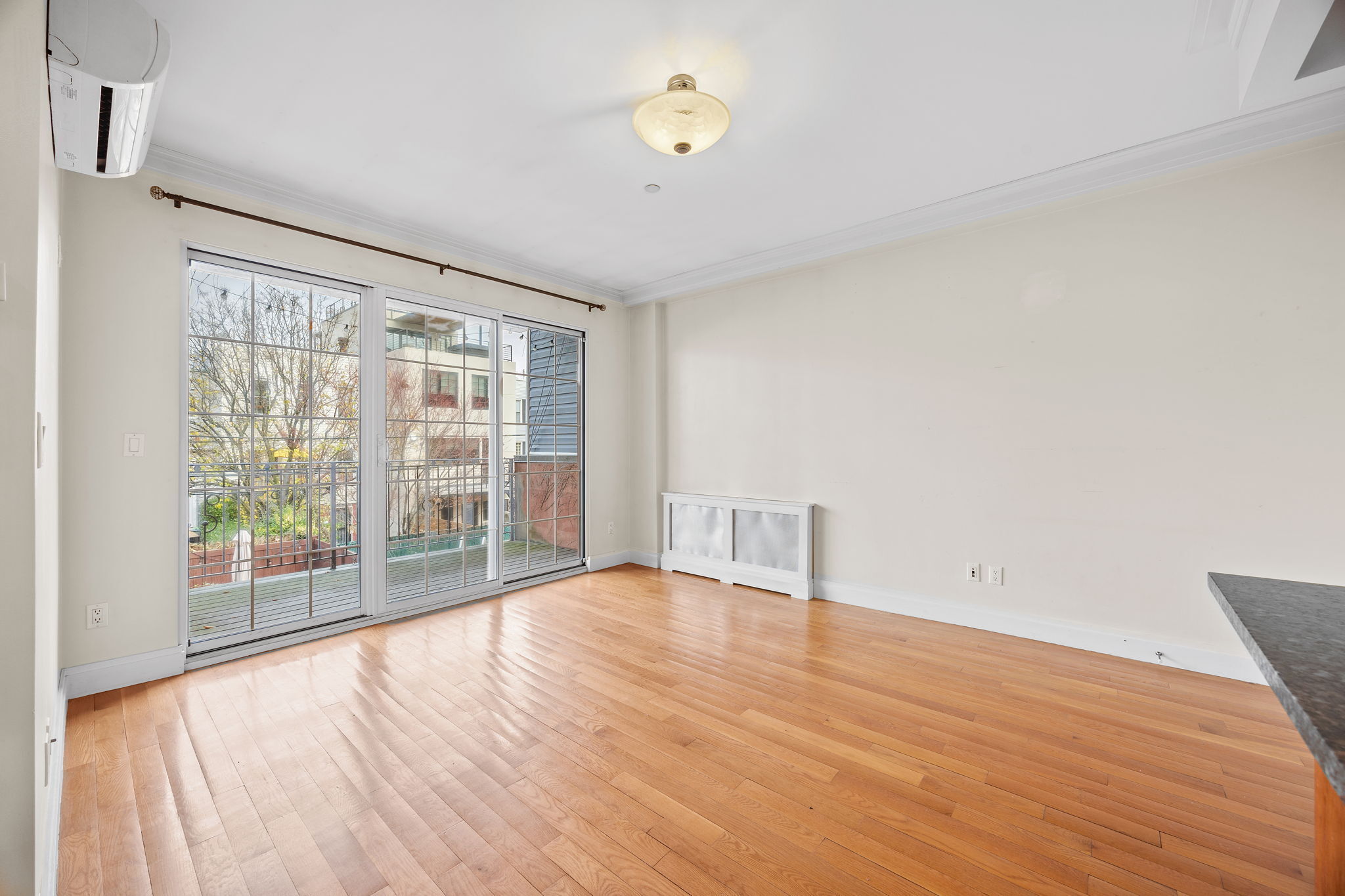 175 12th Street, Unit 2B Brooklyn, NY 11215 - Photo 6 of 20 a view of an empty room with wooden floor and a window