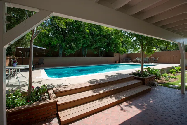 a view of a backyard with sitting area