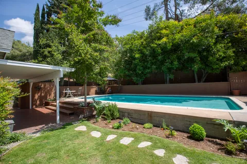 a view of a backyard with sitting area