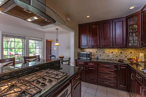 a kitchen with wooden cabinets and appliances