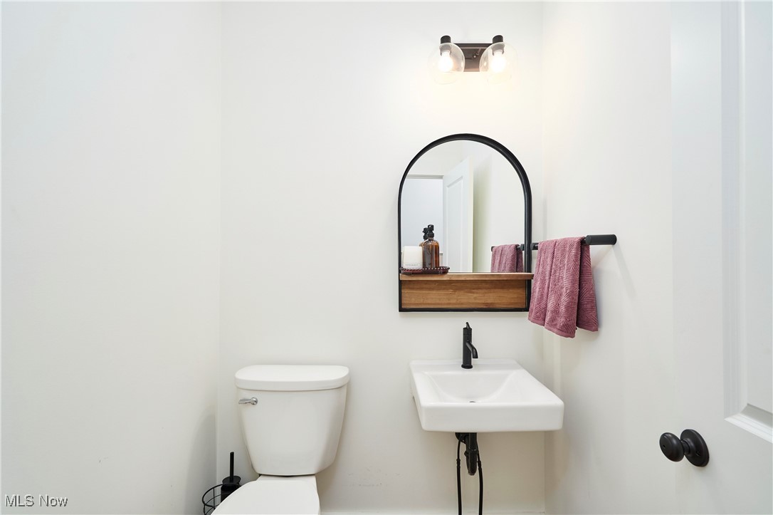 7754 Bainbridge Road Chagrin Falls, OH 44023 - Photo 16 of 35 Half bathroom featuring toilet and a sink