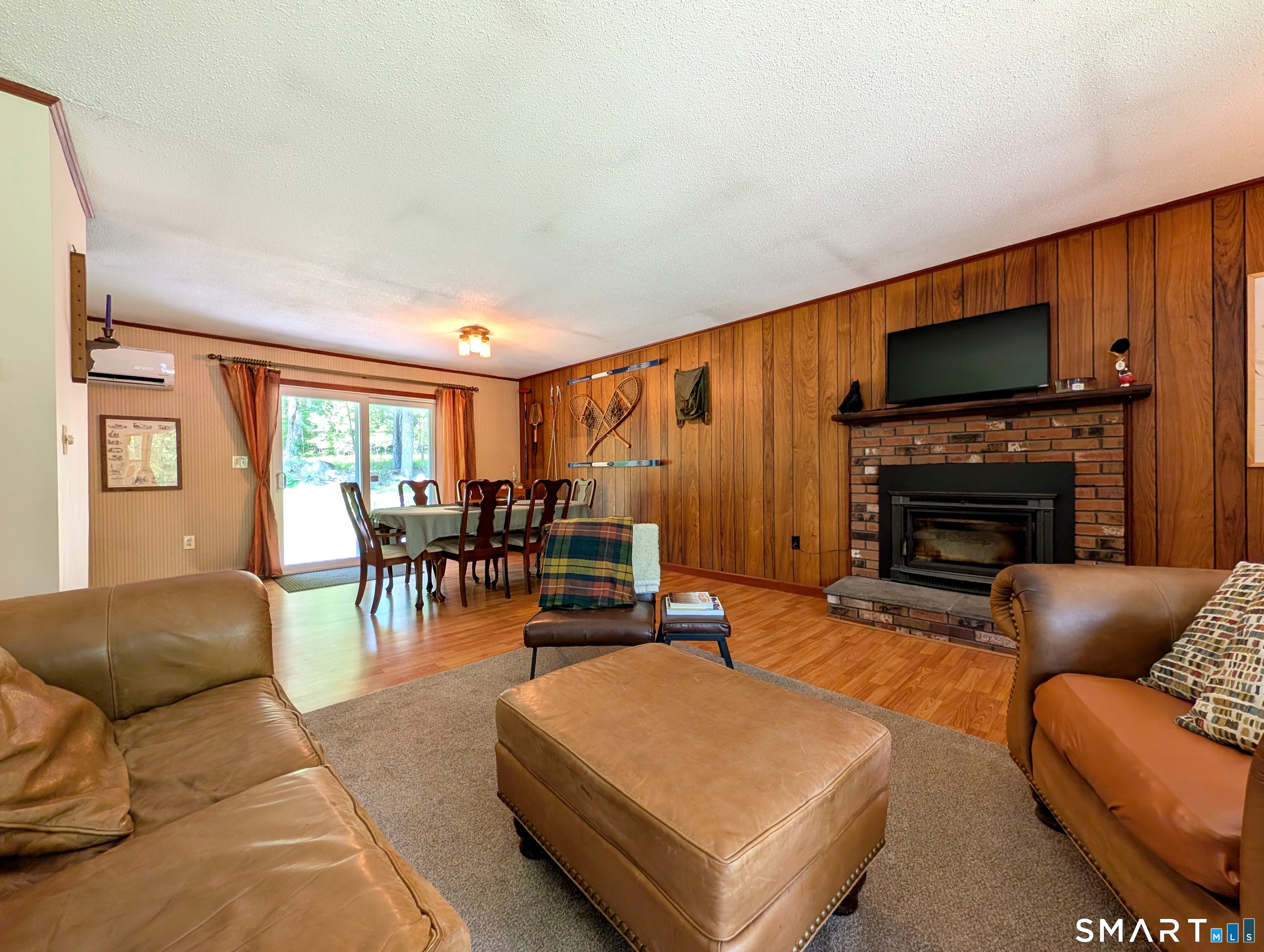 17 Colebrook Road Norfolk, CT 06058 - Photo 9 of 21 a living room with furniture a flat screen tv and a fireplace