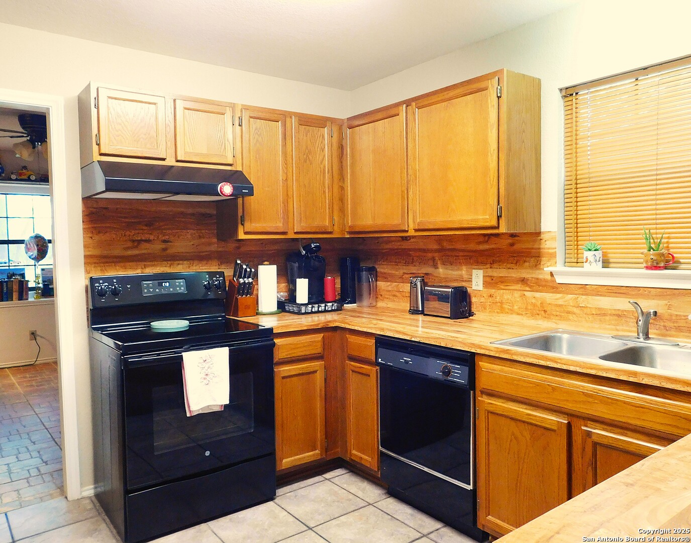 525 Cherry Ridge Floresville, TX 78114 - Photo 12 of 33 a kitchen with stainless steel appliances granite countertop a stove a sink and a microwave