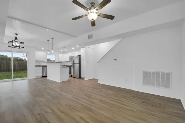 a view of a kitchen with a sink and cabinet area with wooden floor