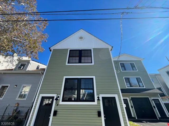 a view of a brick house with large windows