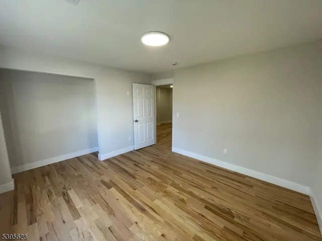 a view of an empty room and wooden floor