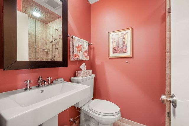 a bathroom with a sink mirror vanity and toilet