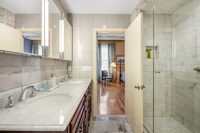 a bathroom with double vanity sink and a mirror