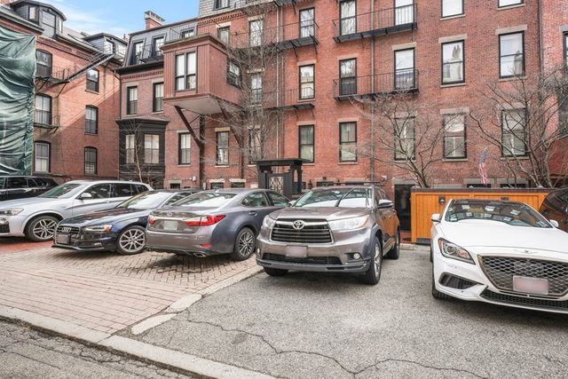 a car parked in front of a brick house