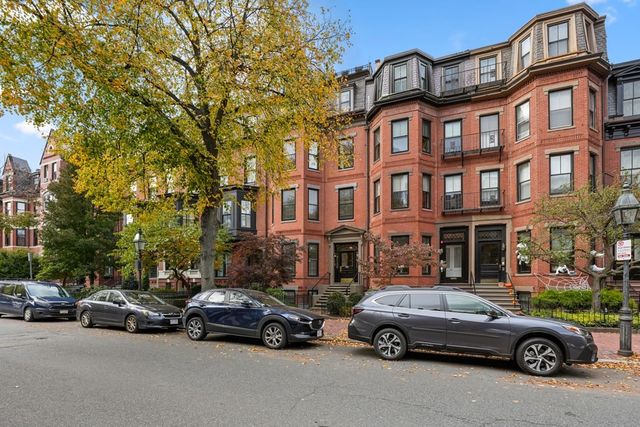 a view of a car parked in front of a building