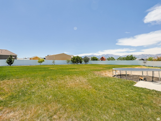 712 East Sunset View Road Grantsville, UT 84029 - Photo 7 of 44 Large backyard with a large grassy area. Beautiful vinyl fencing on three sides.