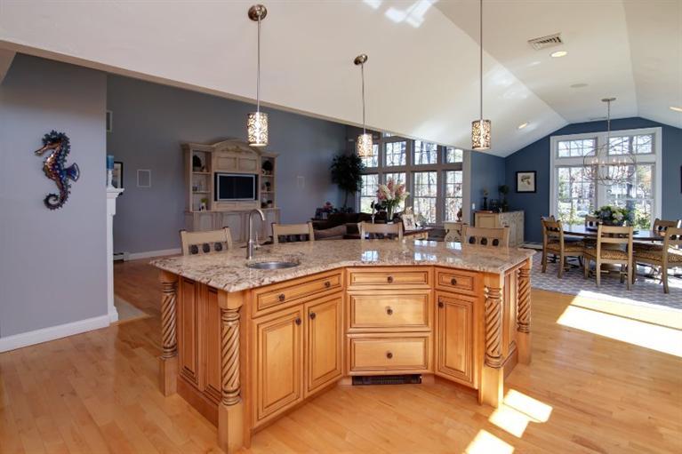 84 Troon Way Mashpee, MA 02649 - Photo 11 of 31 a kitchen with kitchen island granite countertop a sink a counter top space and living room view