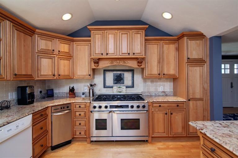 84 Troon Way Mashpee, MA 02649 - Photo 12 of 31 a kitchen with stainless steel appliances granite countertop a stove a sink and a refrigerator