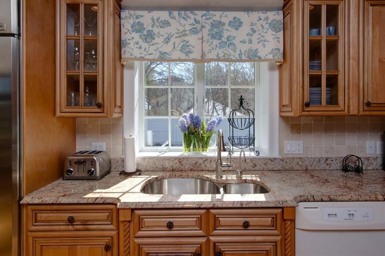 84 Troon Way Mashpee, MA 02649 - Photo 13 of 31 a kitchen with granite countertop a sink and a stove next to a window