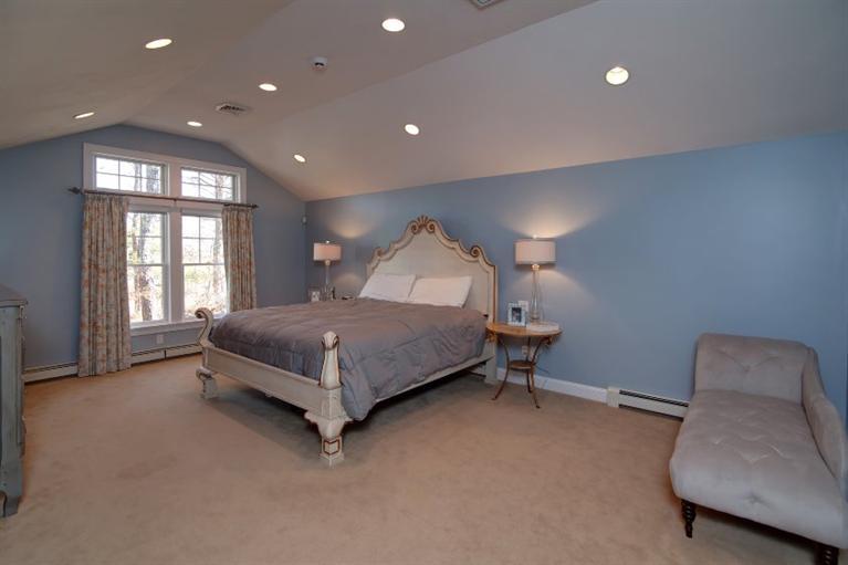 84 Troon Way Mashpee, MA 02649 - Photo 19 of 31 a spacious bedroom with a bed and a couch
