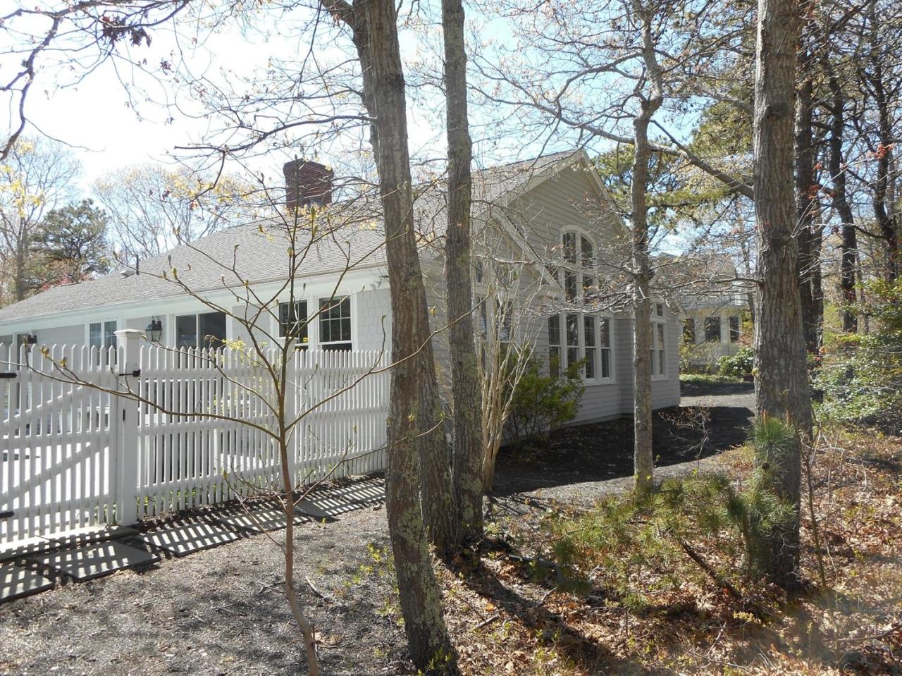 84 Troon Way Mashpee, MA 02649 - Photo 4 of 31 a view of a house with a yard covered with snow in the background