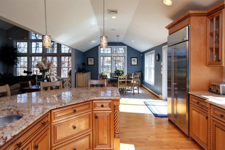 84 Troon Way Mashpee, MA 02649 - Photo 9 of 31 a kitchen with stainless steel appliances granite countertop a refrigerator a stove and a sink with granite countertops