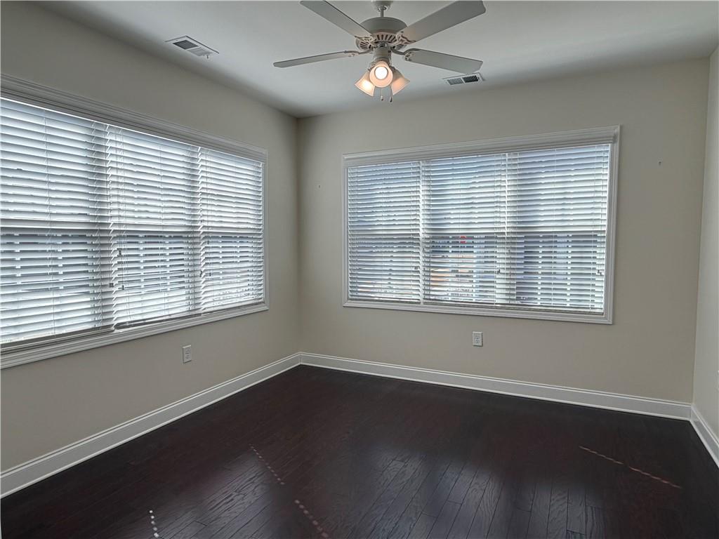 3329 Ivy Ridge Court, Unit 791 Buford, GA 30519 - Photo 11 of 36 a view of an empty room with wooden floor and a window