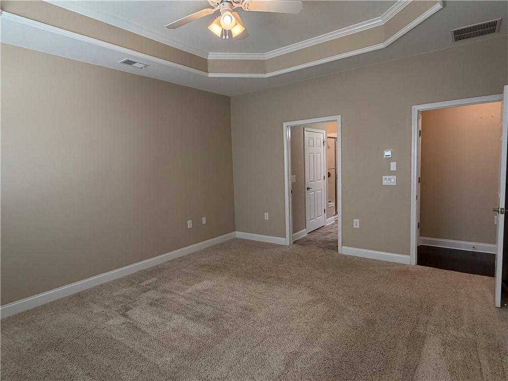3329 Ivy Ridge Court, Unit 791 Buford, GA 30519 - Photo 17 of 36 an empty room with a chandelier fan and windows