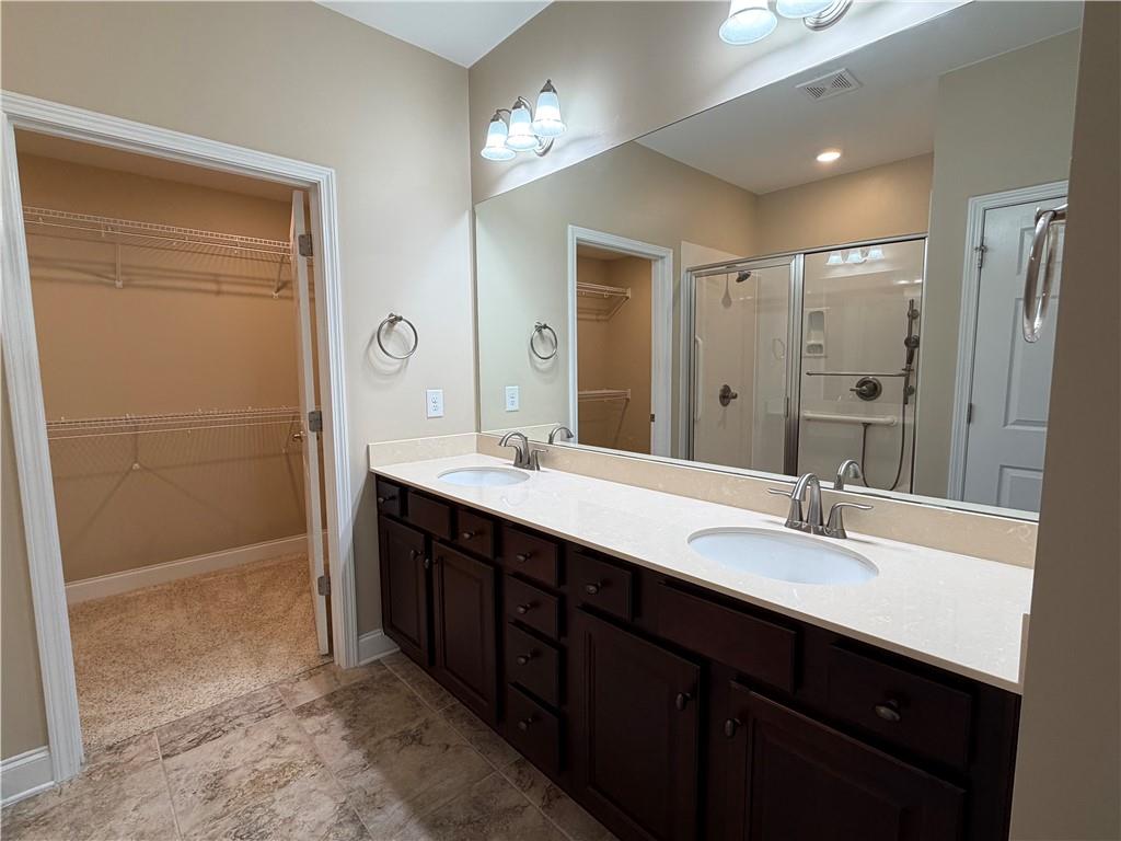 3329 Ivy Ridge Court, Unit 791 Buford, GA 30519 - Photo 18 of 36 a bathroom with double sink and two mirror