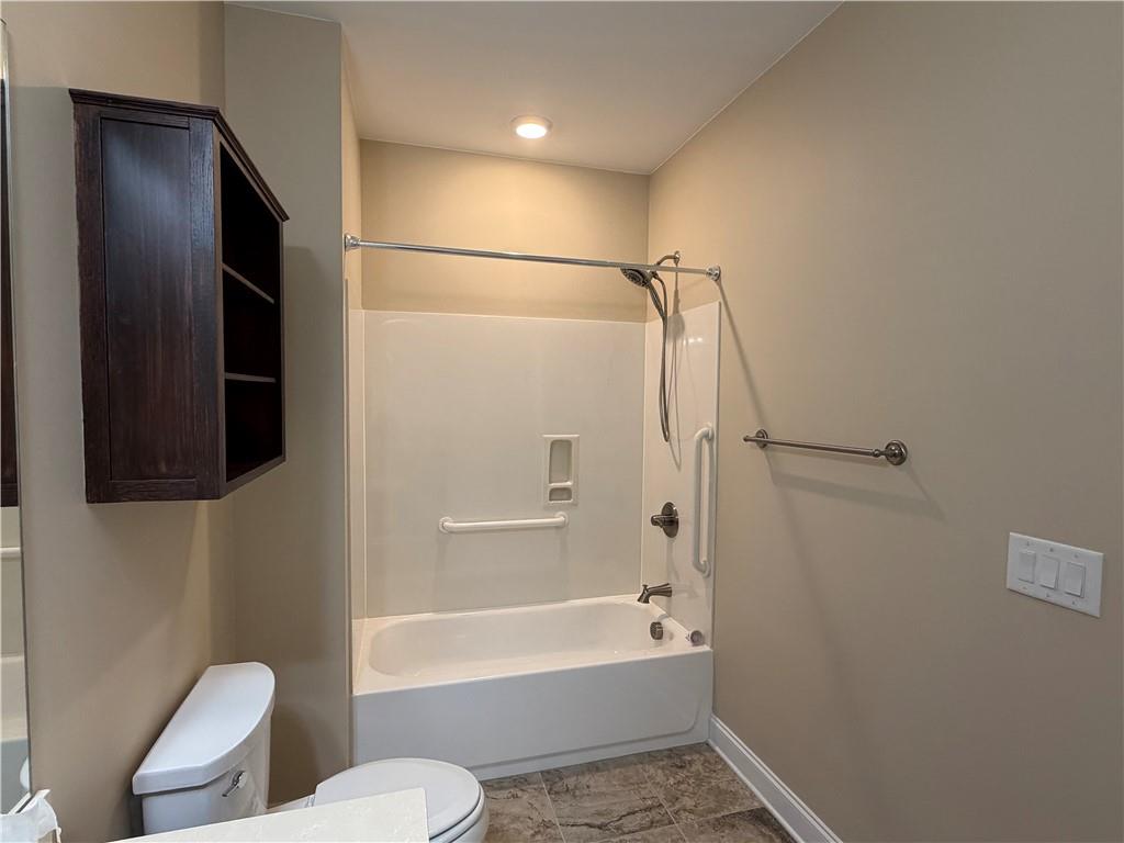 3329 Ivy Ridge Court, Unit 791 Buford, GA 30519 - Photo 24 of 36 a bathroom with a toilet and a bath tub