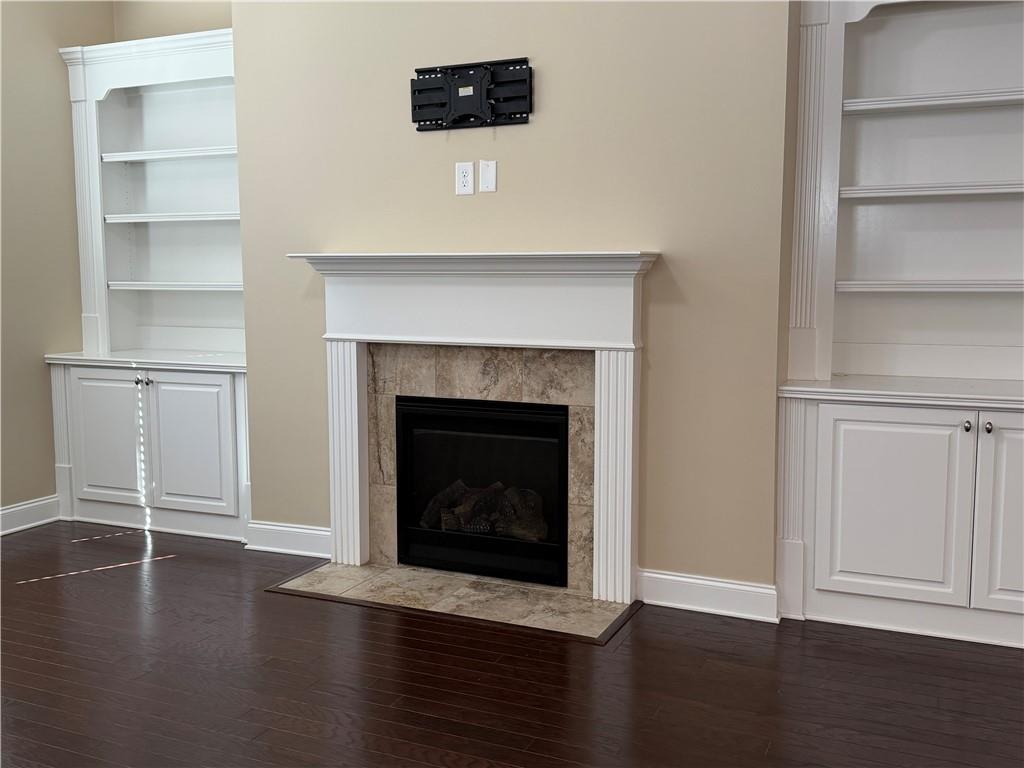 3329 Ivy Ridge Court, Unit 791 Buford, GA 30519 - Photo 8 of 36 a view of a livingroom with wooden floor and a fireplace