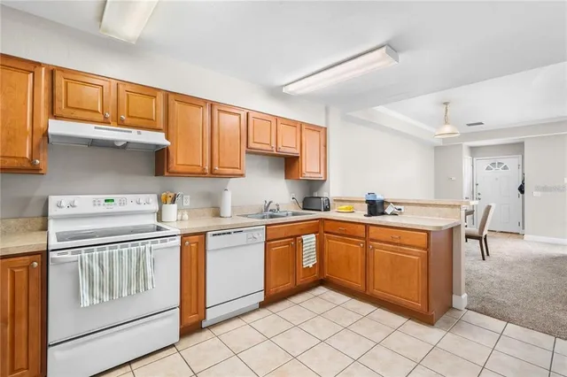 a kitchen with stainless steel appliances granite countertop a sink and cabinets