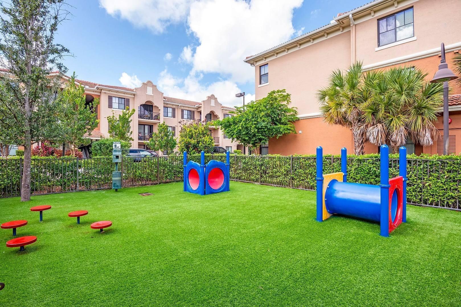 16808 Southwest 137th Avenue, Unit 922 Miami, FL 33177 - Photo 13 of 14 a view of a backyard with plants and palm trees